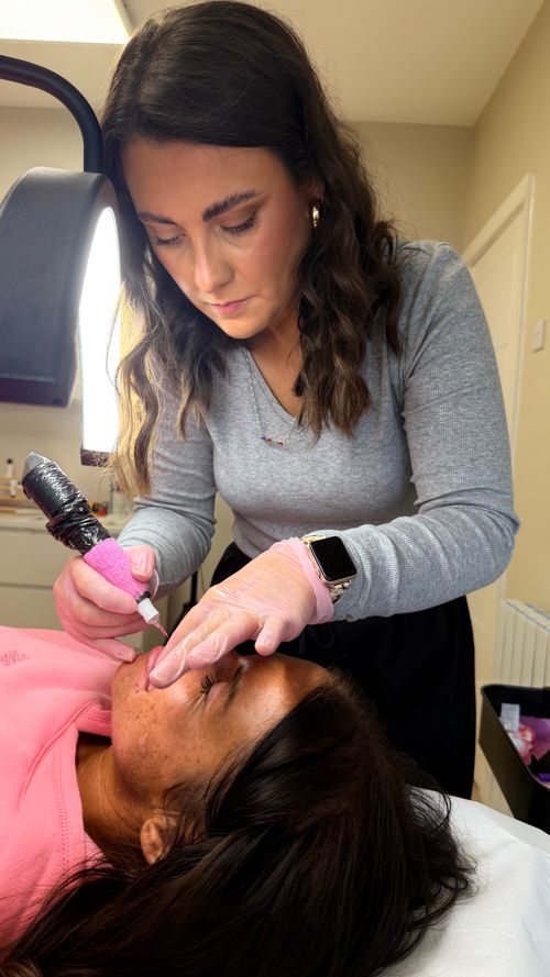 Emily from Ori Studio providing lip blush to a client