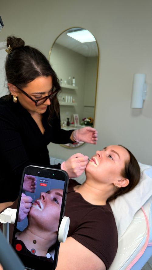 Emily from Ori Studio providing lip blush to a client