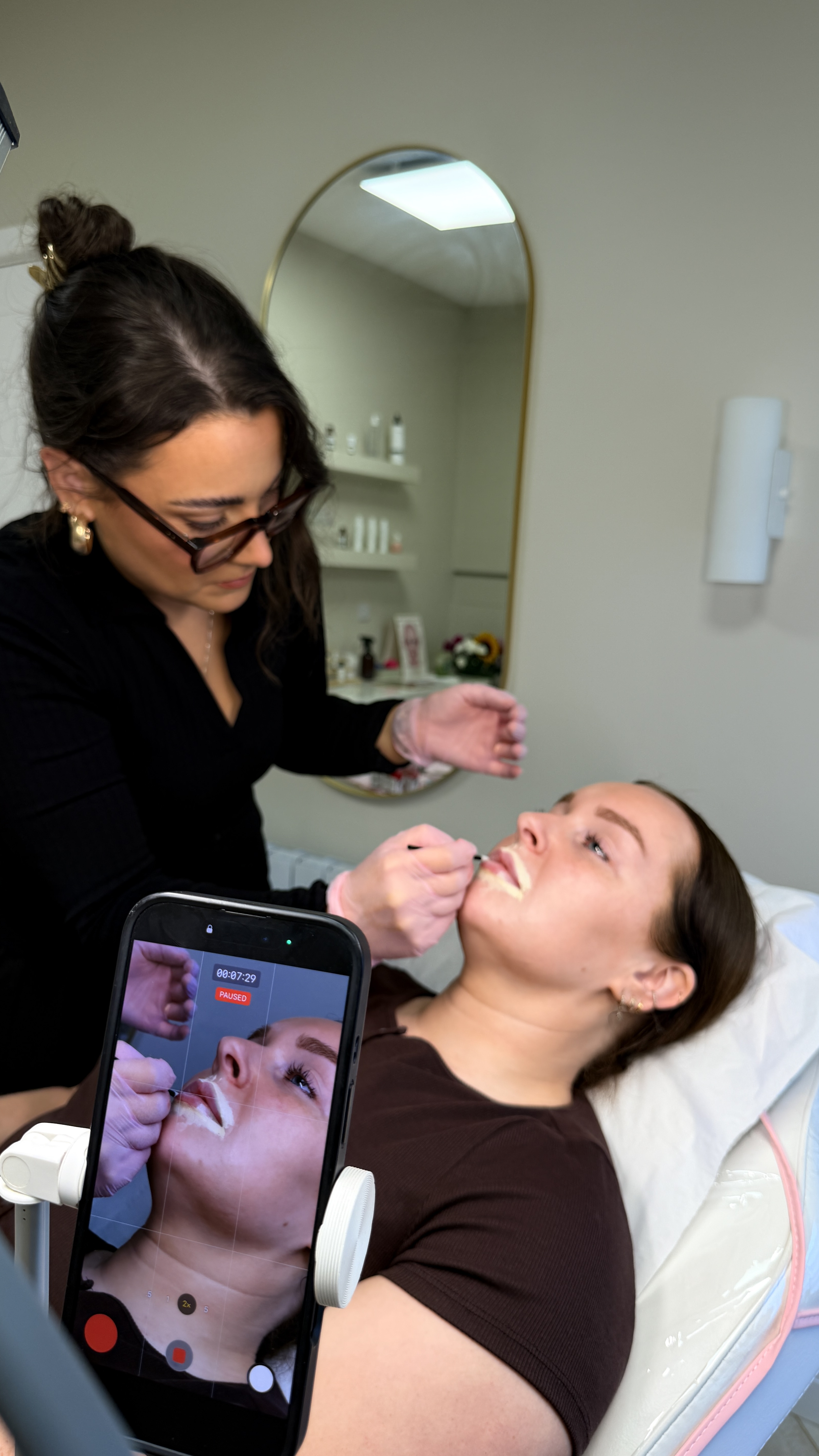 Emily from Ori Studio providing lip blush to a client