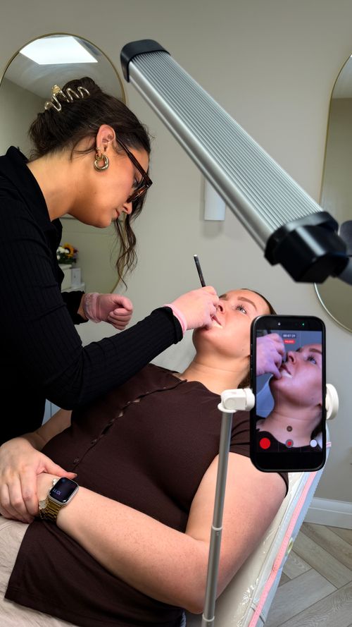 Emily from Ori Studio providing lip blush to a client