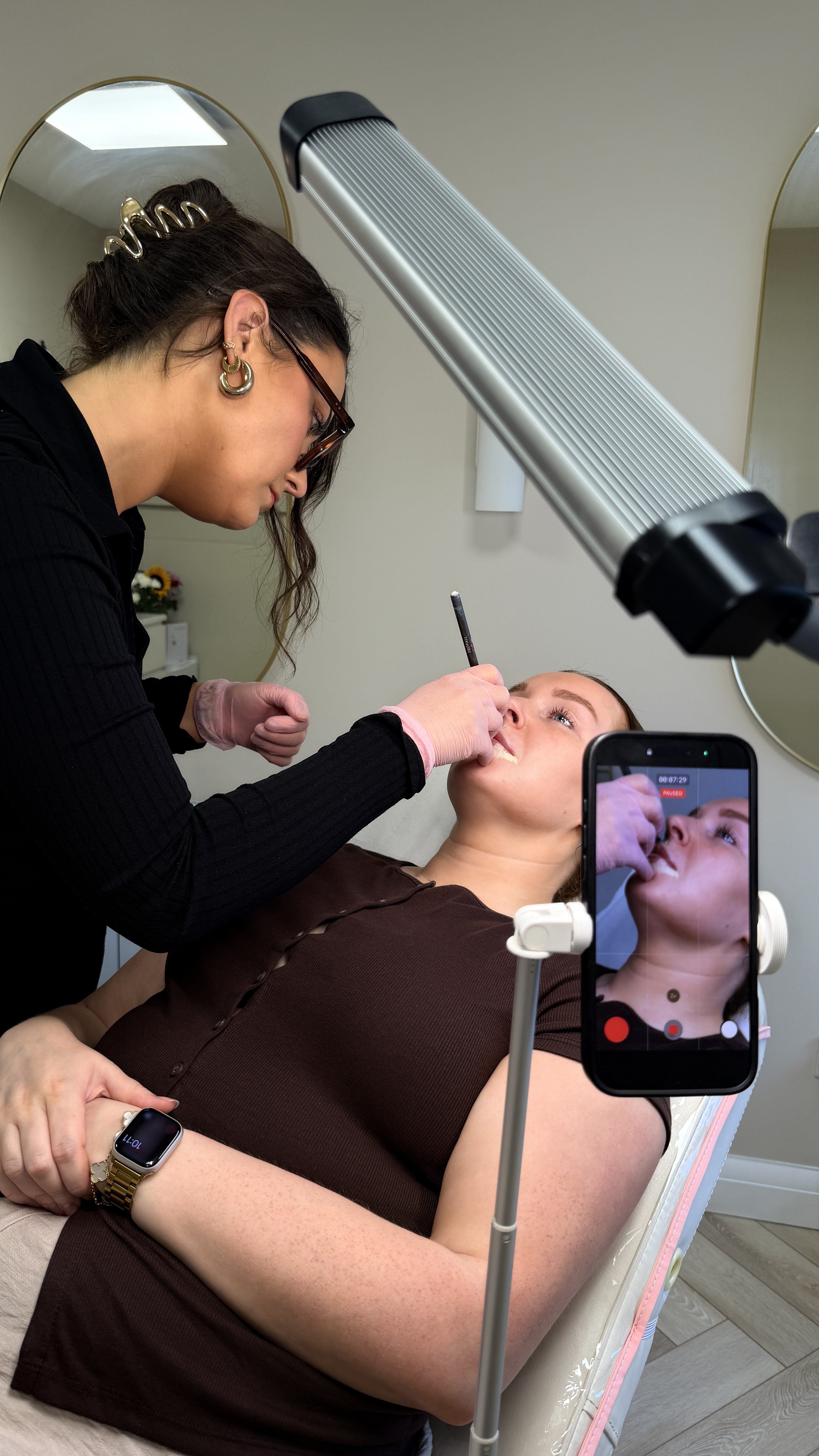 Emily from Ori Studio providing lip blush to a client