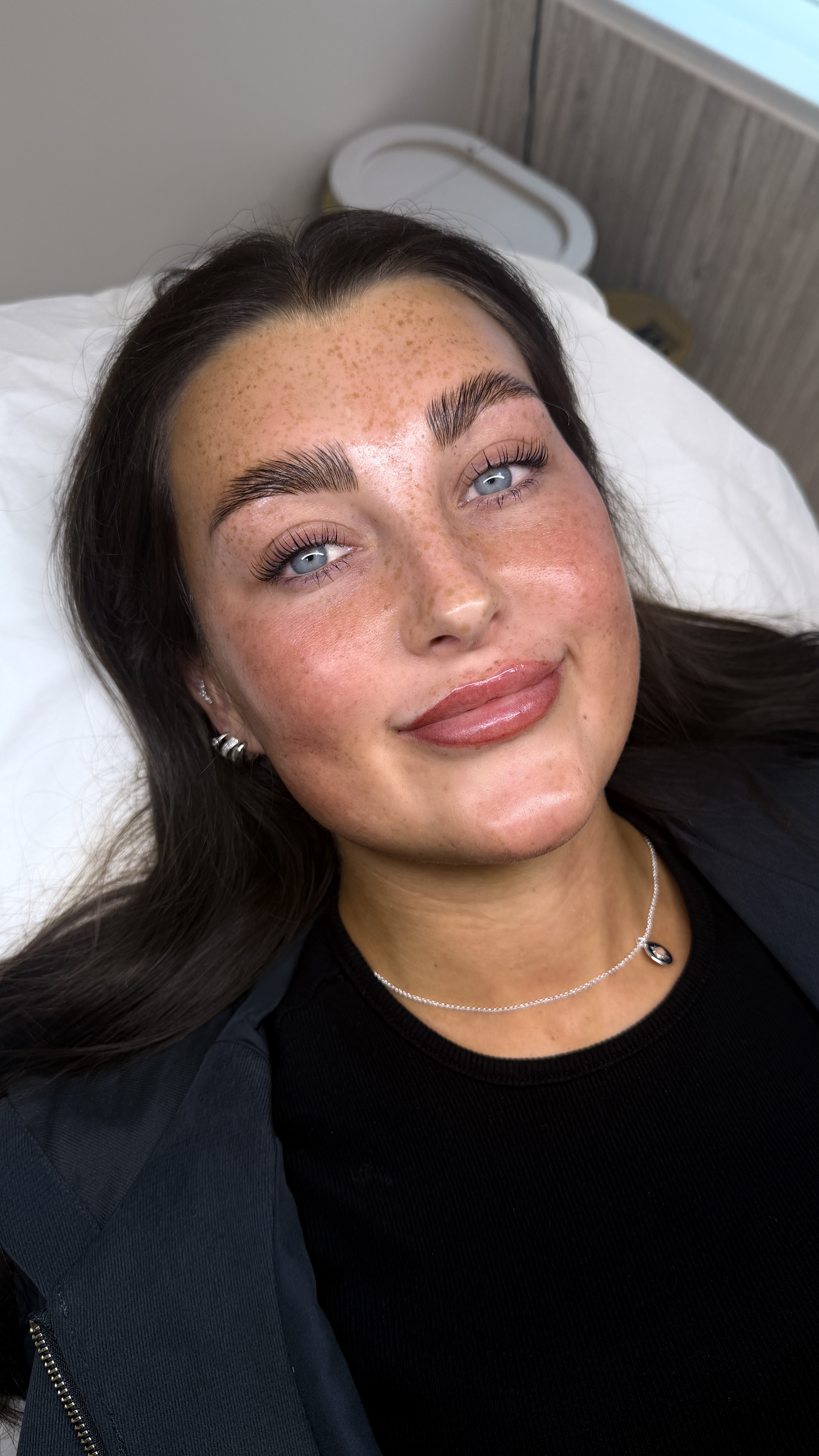 Woman laying on treatment bed at Ori Studio