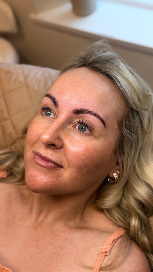 Woman laying on treatment bed at Ori Studio