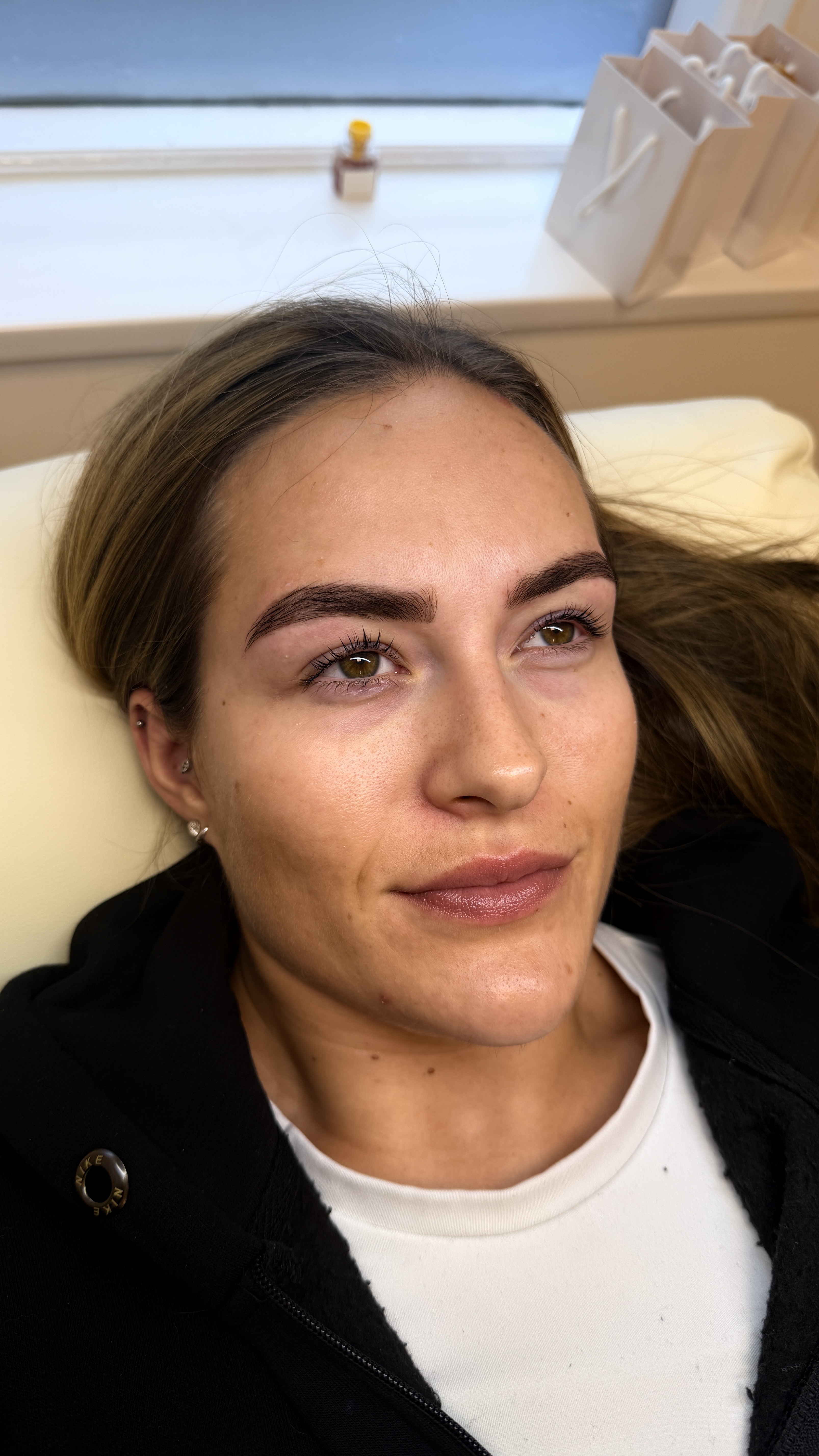 Woman laying on treatment bed at Ori Studio