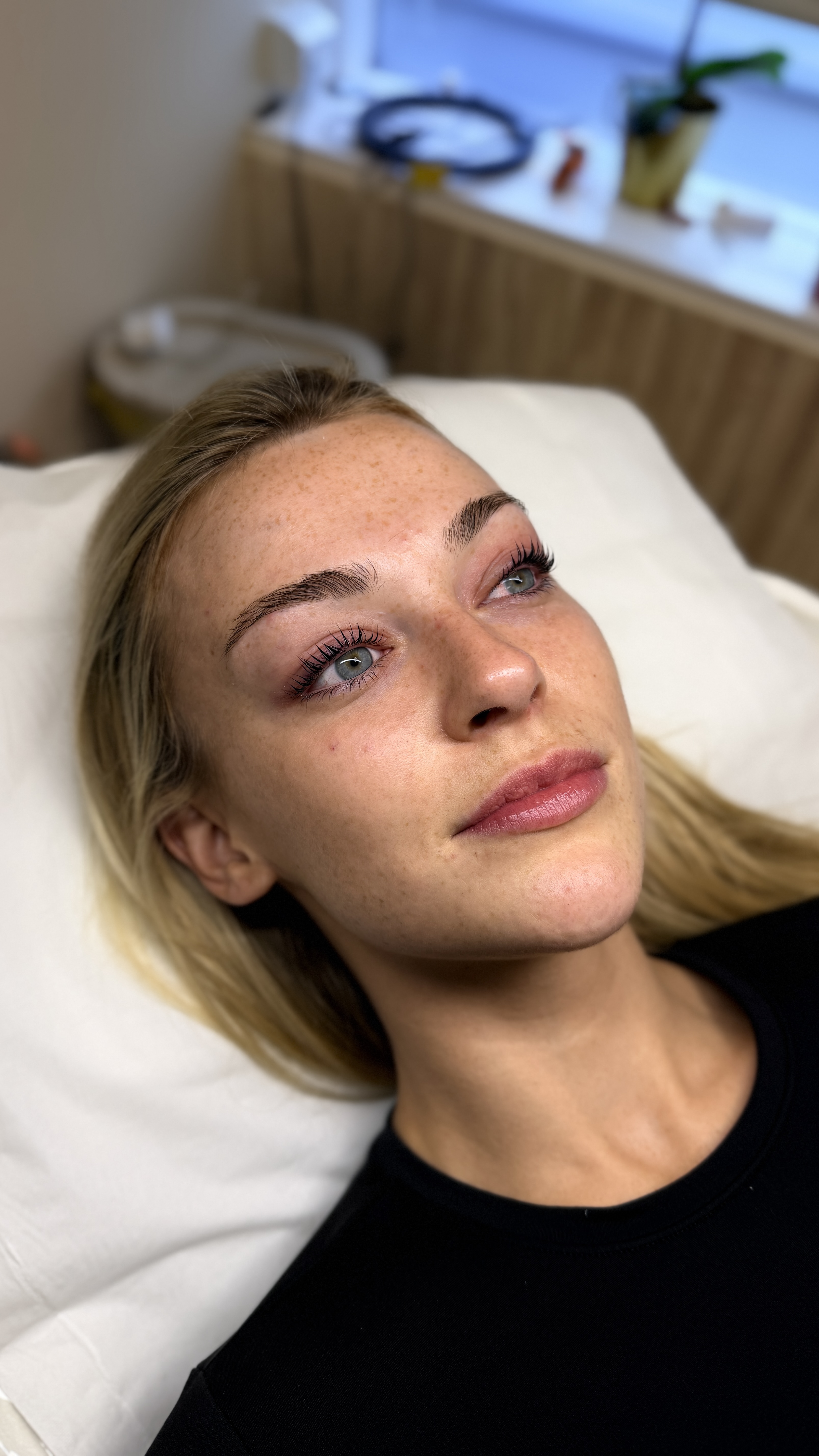 Woman laying on treatment bed at Ori Studio