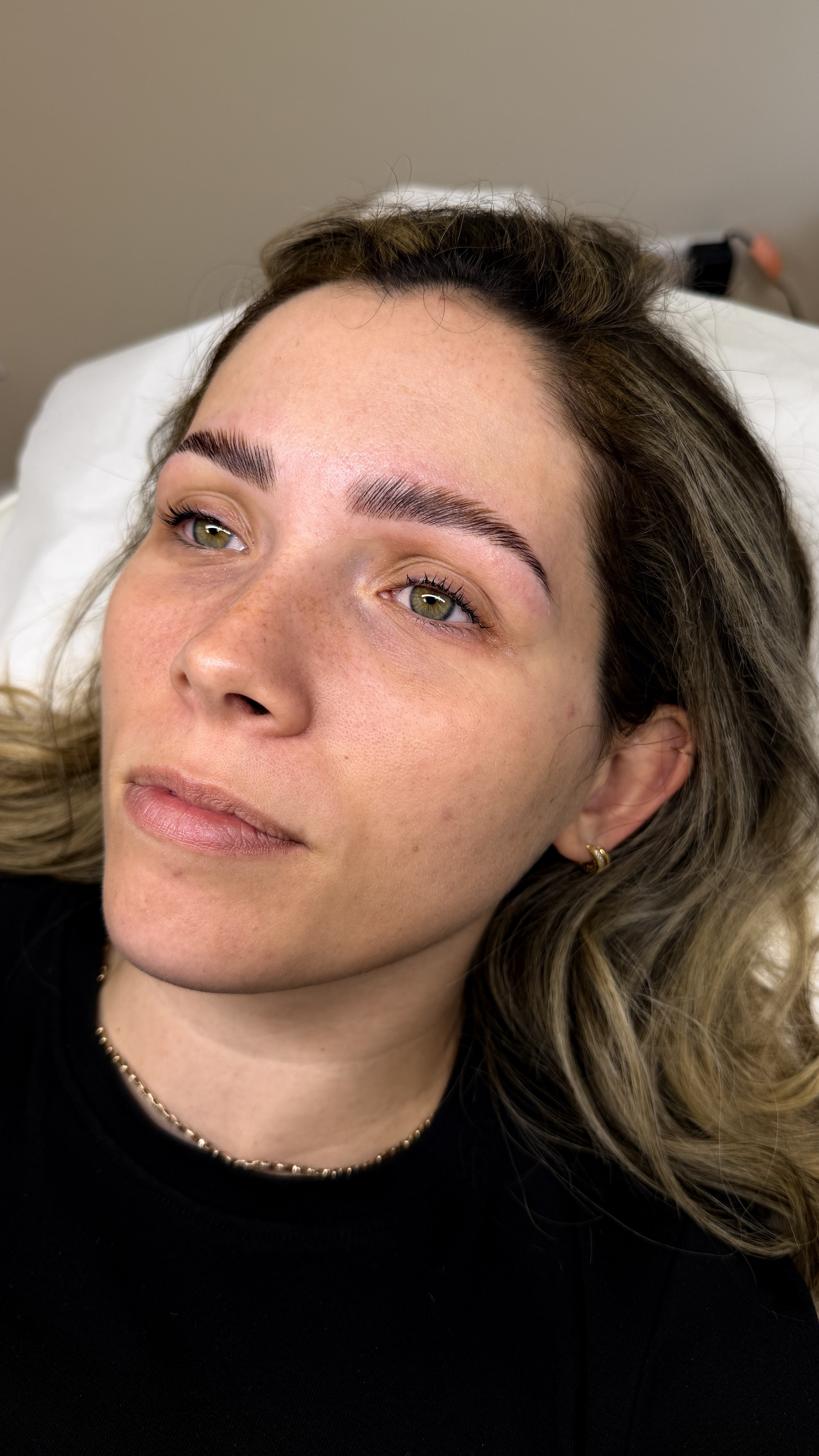 Woman laying on treatment bed at Ori Studio