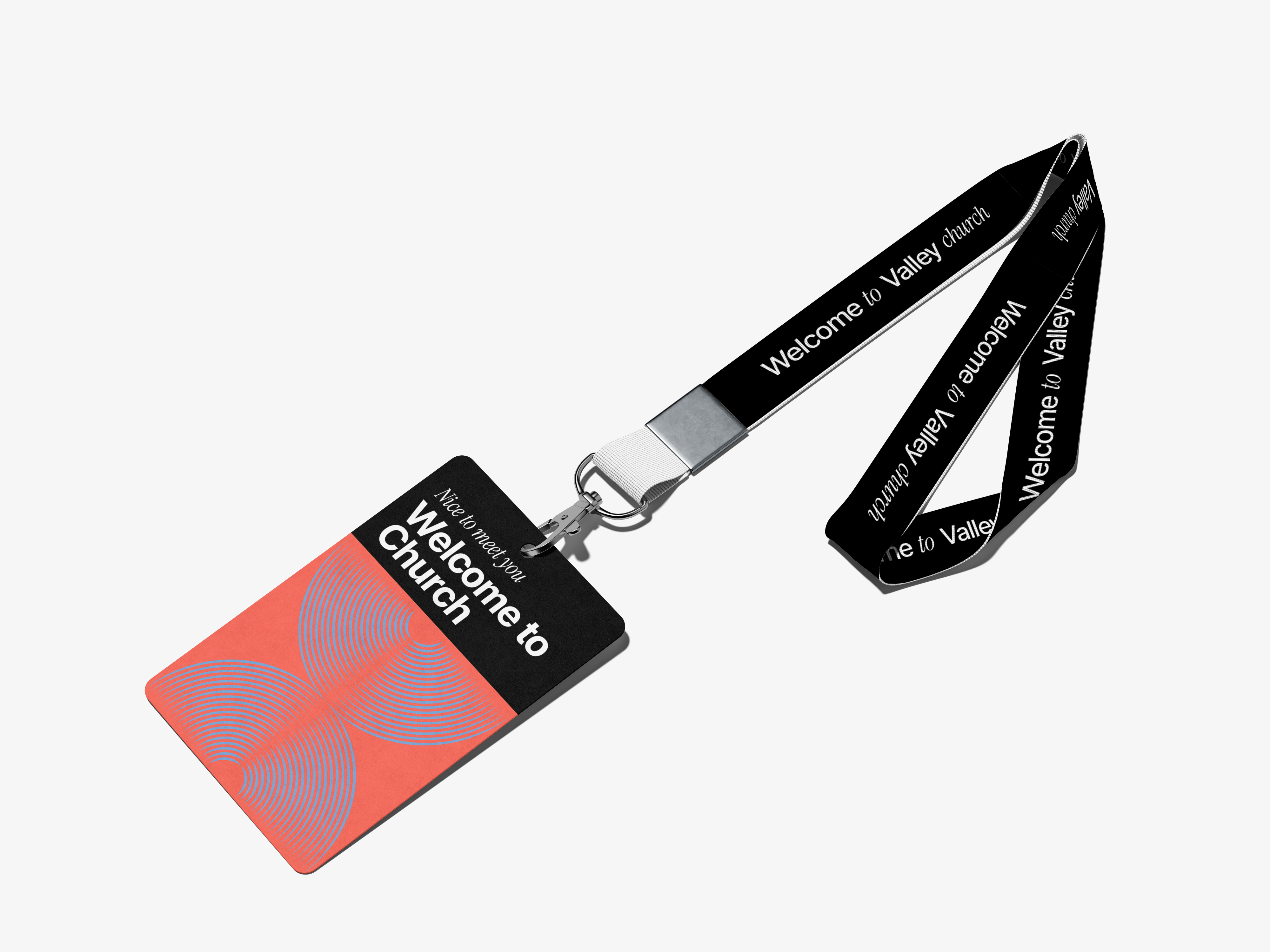 Black and red conference badge with concentric circle design, reading 'Nice to meet you Welcome to Church' attached to a black lanyard printed with 'Welcome to Valley Church'.