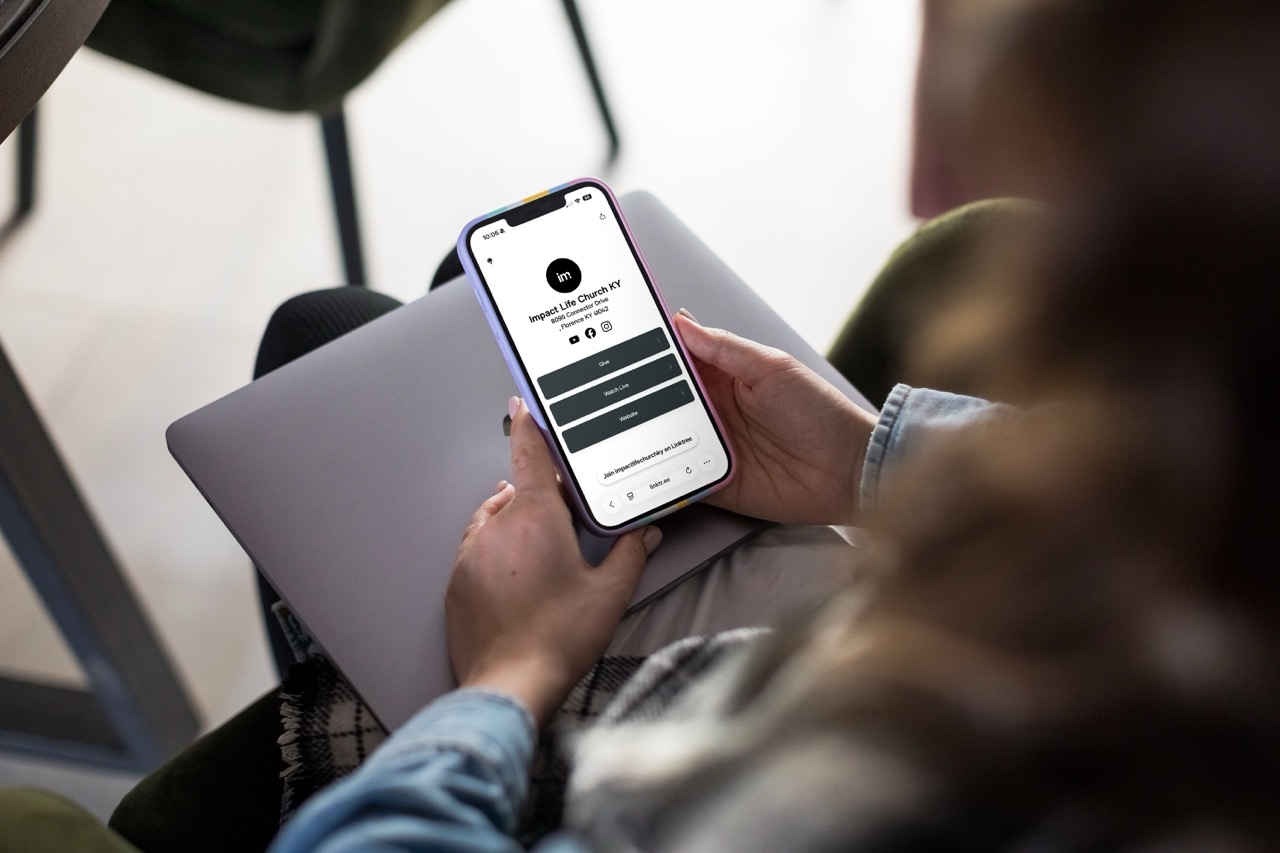 Smartphone screen displaying the word 'IMPACT' in white letters on a red background.