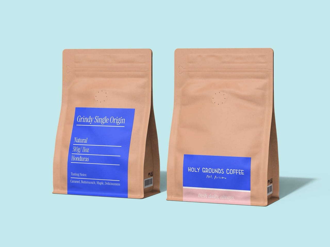 Two brown coffee bags with blue labels on a light blue background; the left label reads 'Grindy Single Origin' from Honduras, and the right label reads 'HOLY GROUNDS COFFEE PHX, Arizona'.