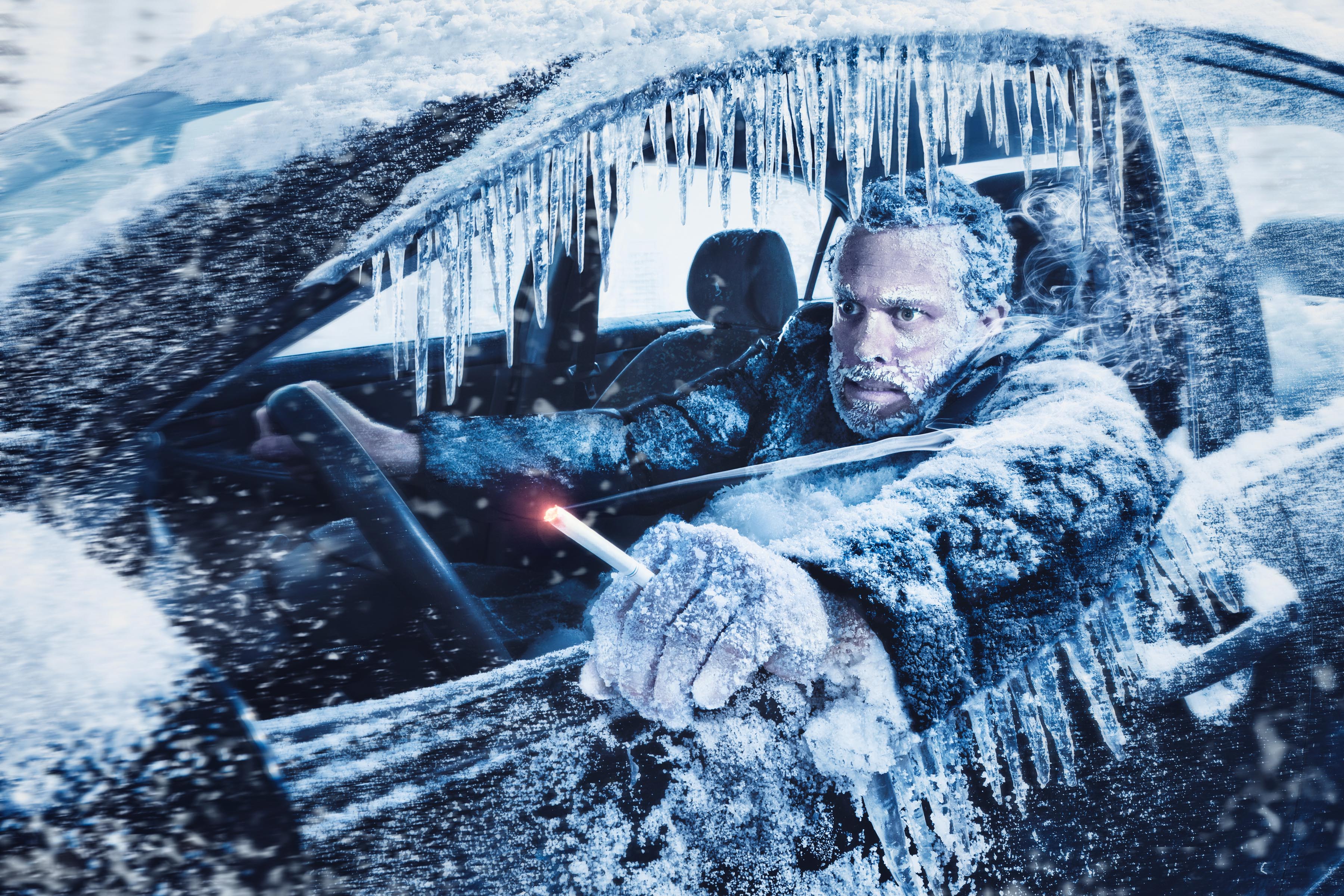 Man frozen inside ice-covered car with icicles hanging from open window frame, Novartis campaign.