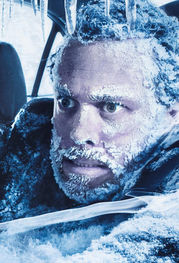Man frozen inside ice-covered car with icicles hanging from window frame, Novartis campaign photograph.