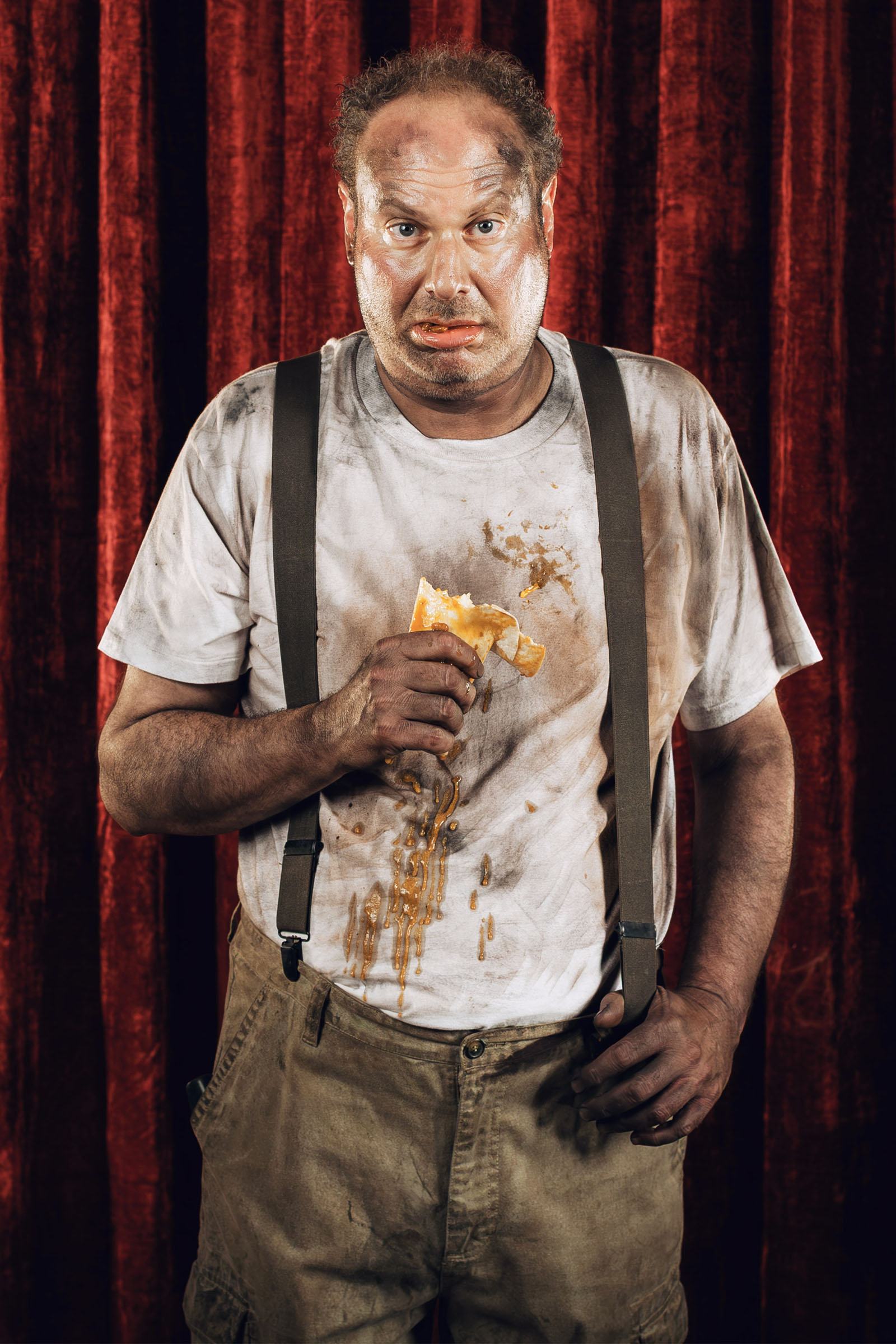 Tow truck driver portrait holding a bean burrito, grease-stained shirt and suspenders, Speedy Auto campaign.