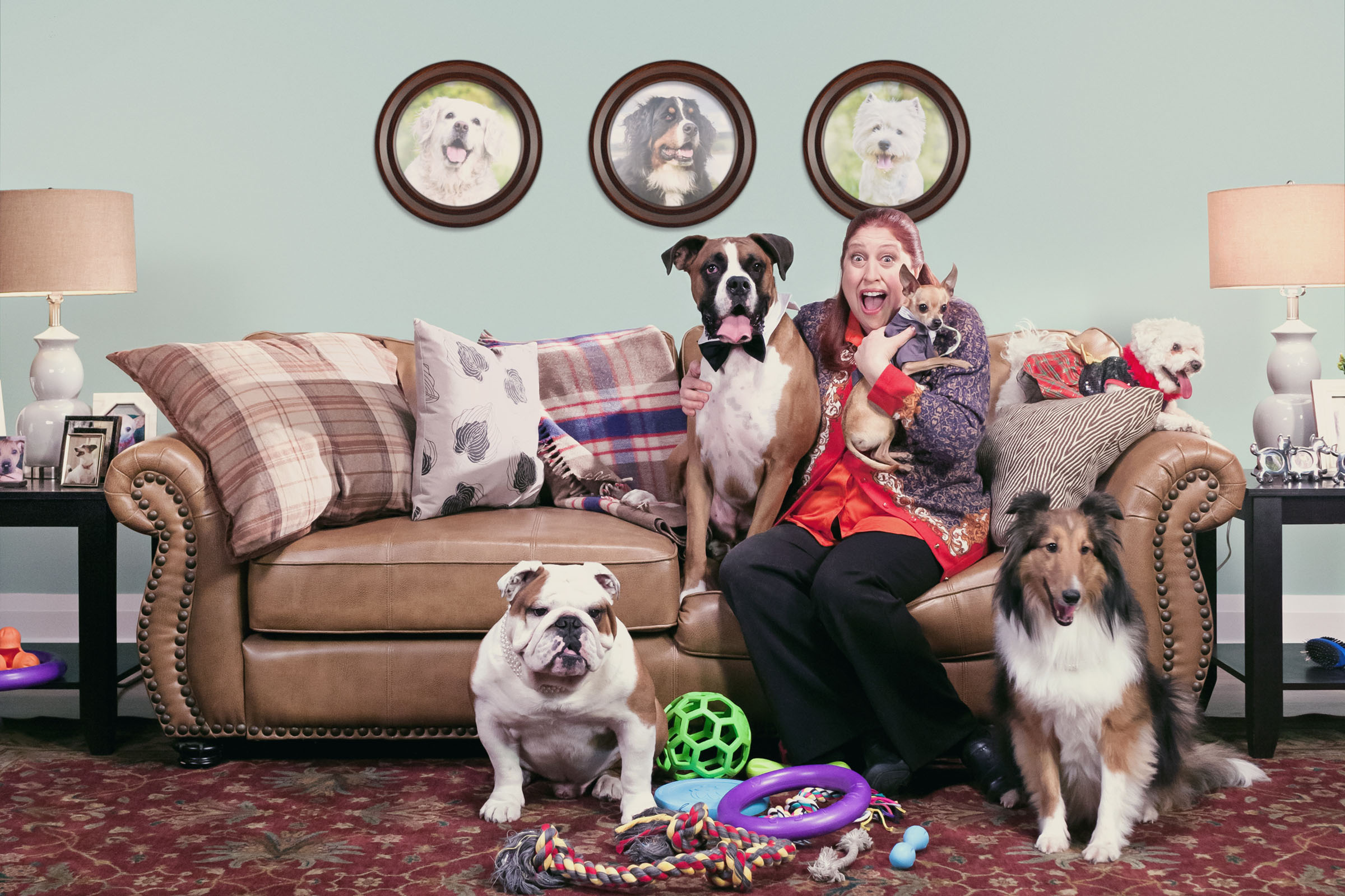 Overjoyed homeowner surrounded by multiple dogs in cluttered living room, Zoocasa campaign.