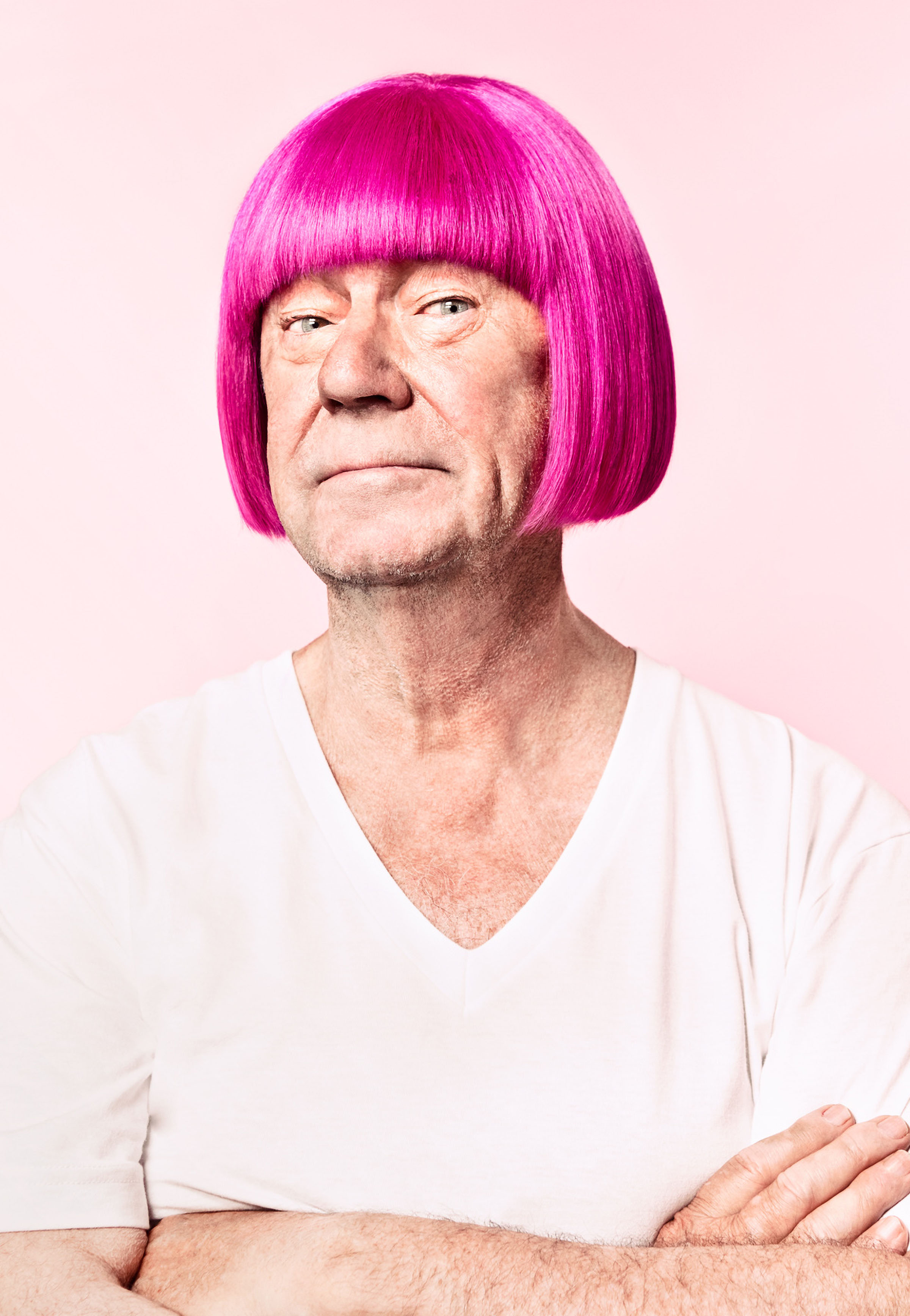 Man wearing bright pink wig and white shirt against pale background, CIBC Run for the Cure campaign