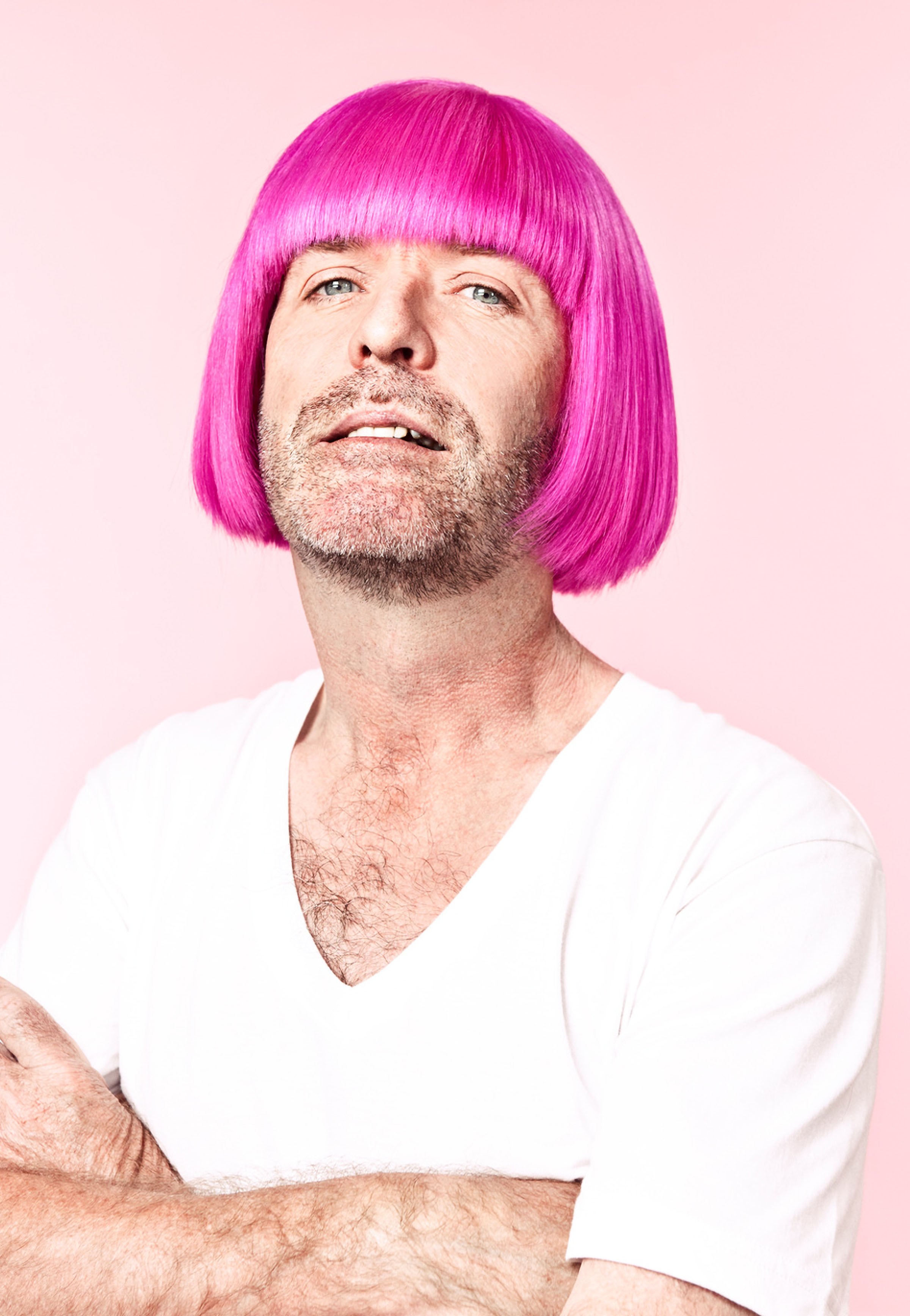Bearded man wearing bright pink wig looking upward against pale background, CIBC Run for the Cure campaign