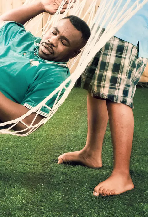 Children lifting father in hammock like a pinata in backyard scene, Ontario Power Generation campaign.