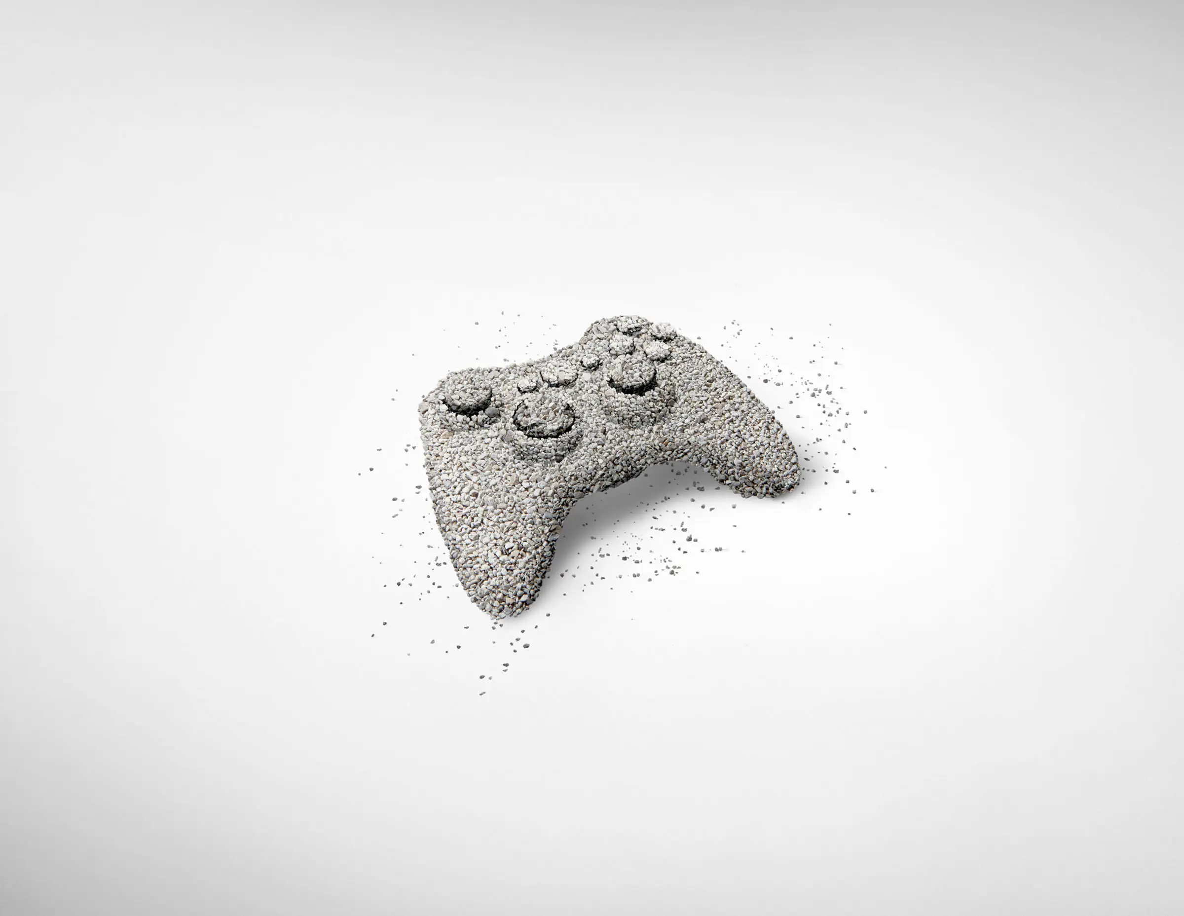Video game controller sculpture made from cat litter on white background, Royal Canin campaign.