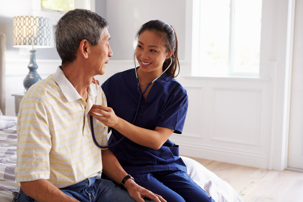 Healthcare professional examining an older man with a stethoscope.
