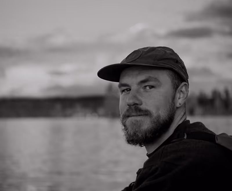 Wholesome Guide Side Front Profile Smiling on a Lake in Black and White