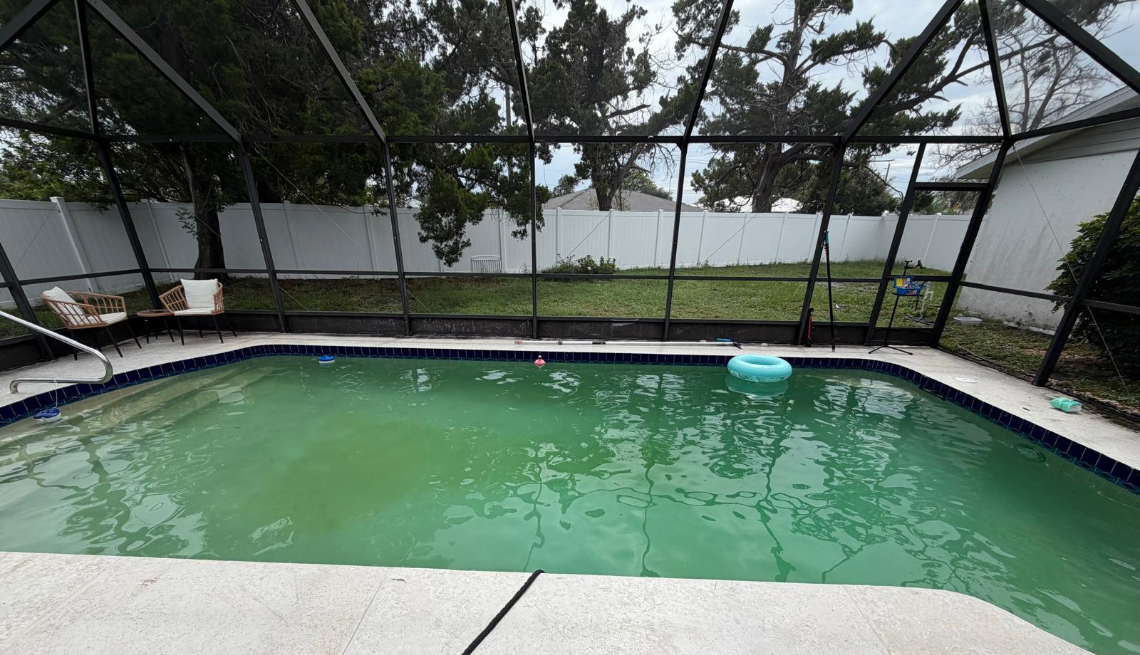 Pool water beginning to turn green, an early sign that professional pool service may be needed.