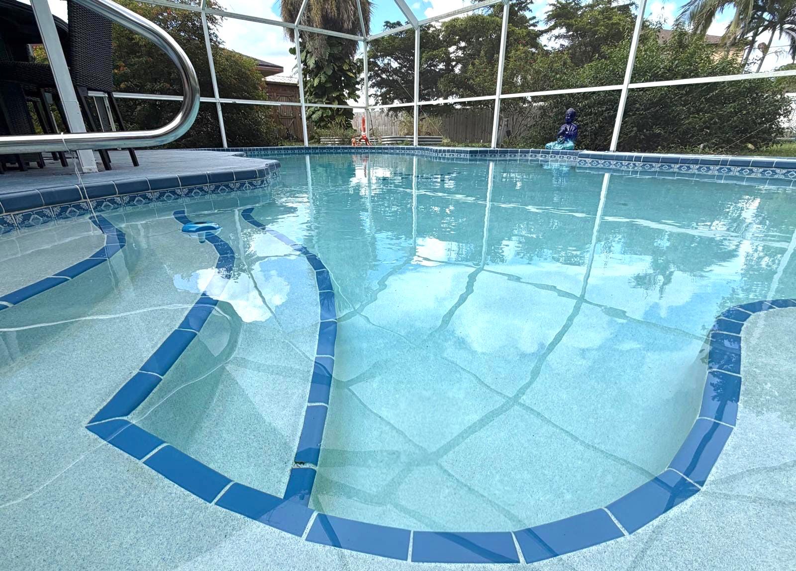 Crystal-clear screened backyard swimming pool in North Port, Florida.