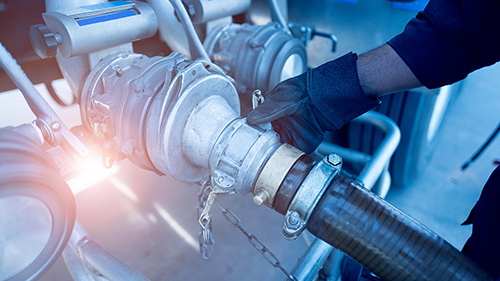 Fuel being transferred from a truck through a hose