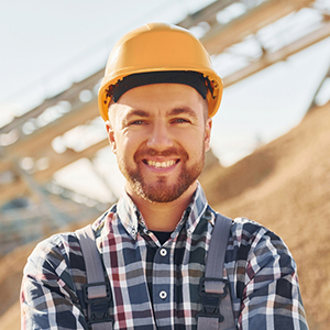 Male worker wearing a hard hat at a quarry site