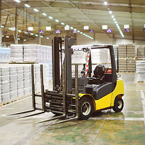 Forklift in warehouse filled with pallets