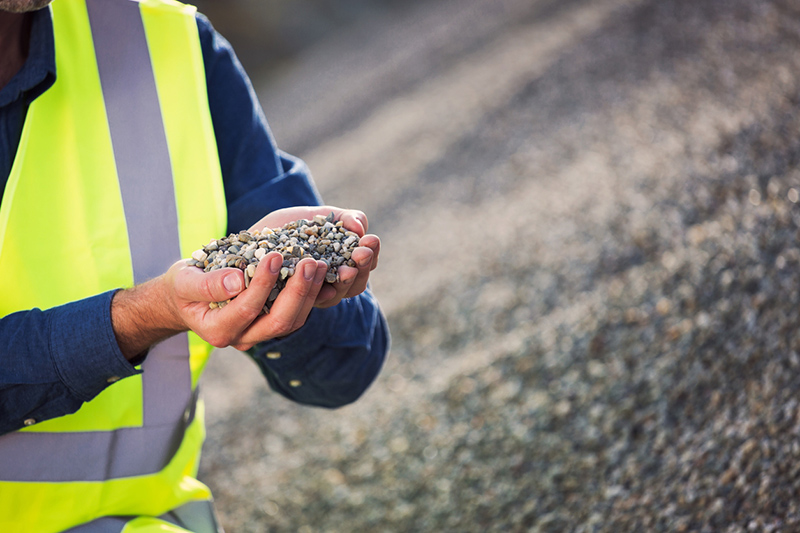 Person holding aggregate gravel bulk