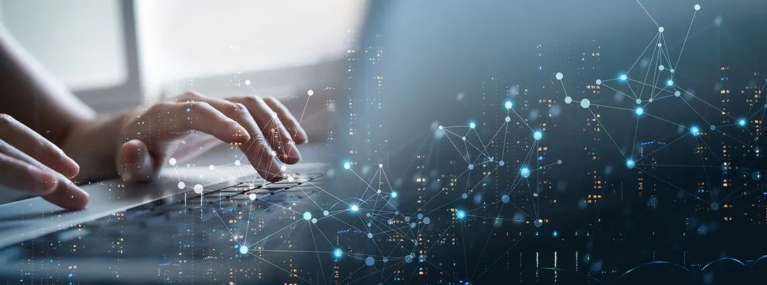 Person typing on laptop with technology graphic above