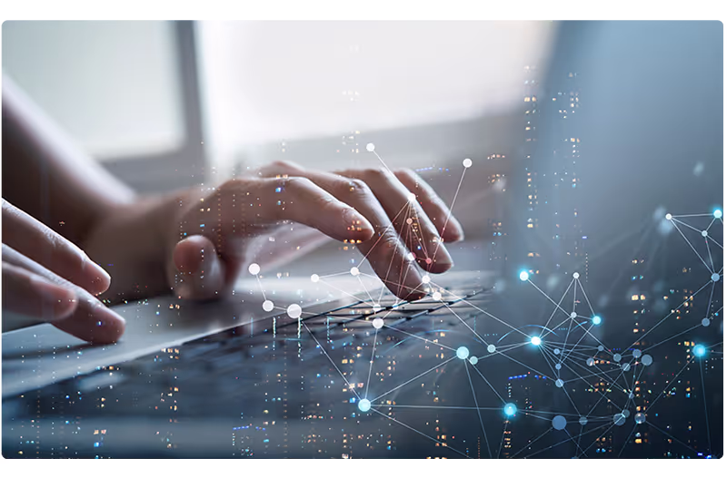 Person typing on laptop with technology graphic above