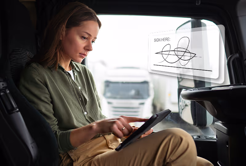 Female driver using tablet in cab, with signature graphic