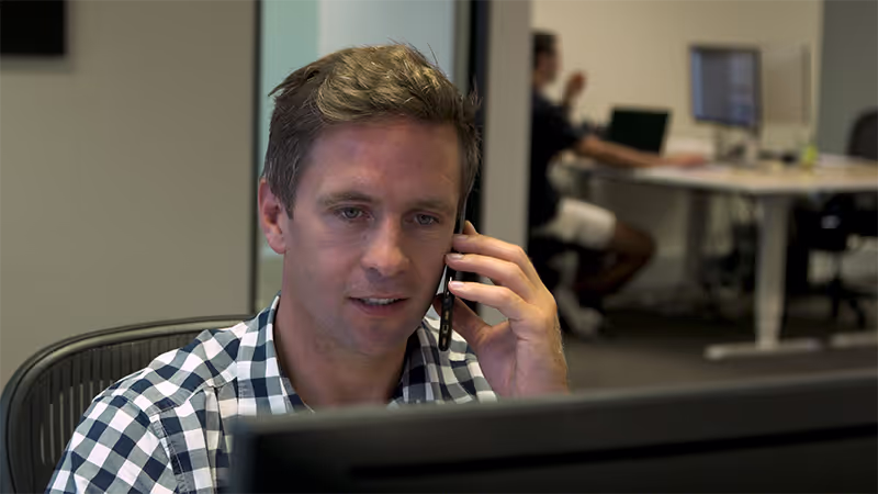 M2X employee on phone