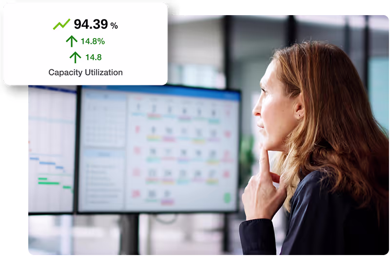 Scheduler planning looking at laptop, with utilisation graphic over top