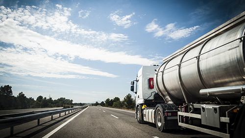 Dairy tanker truck driving down highway