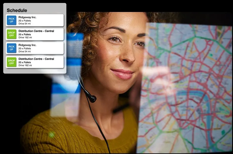 Dispatcher looking at map and driver schedule on computer