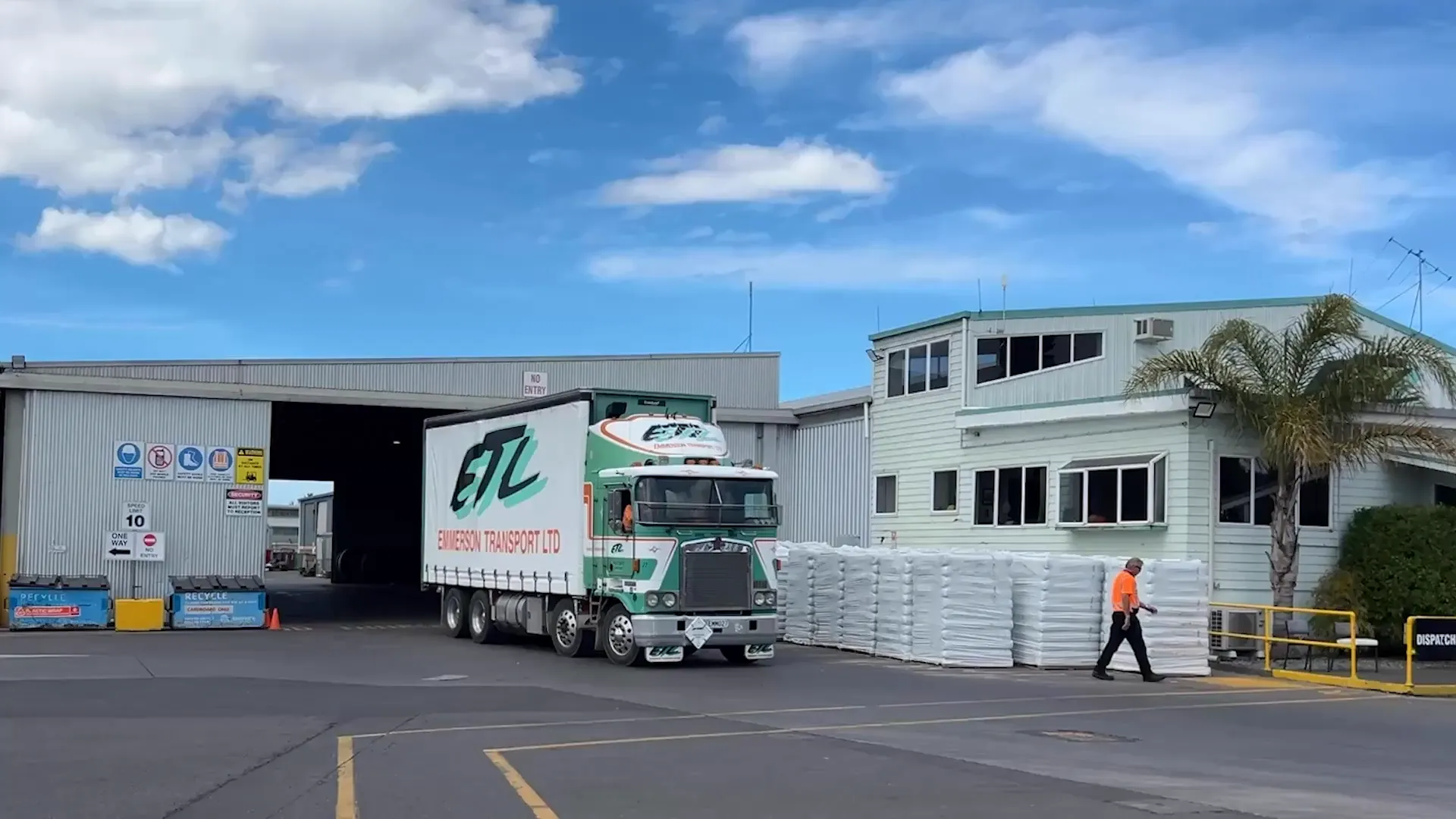M2X and Emmerson Transport logos over a photo of an Emmerson Transport truck at the depot