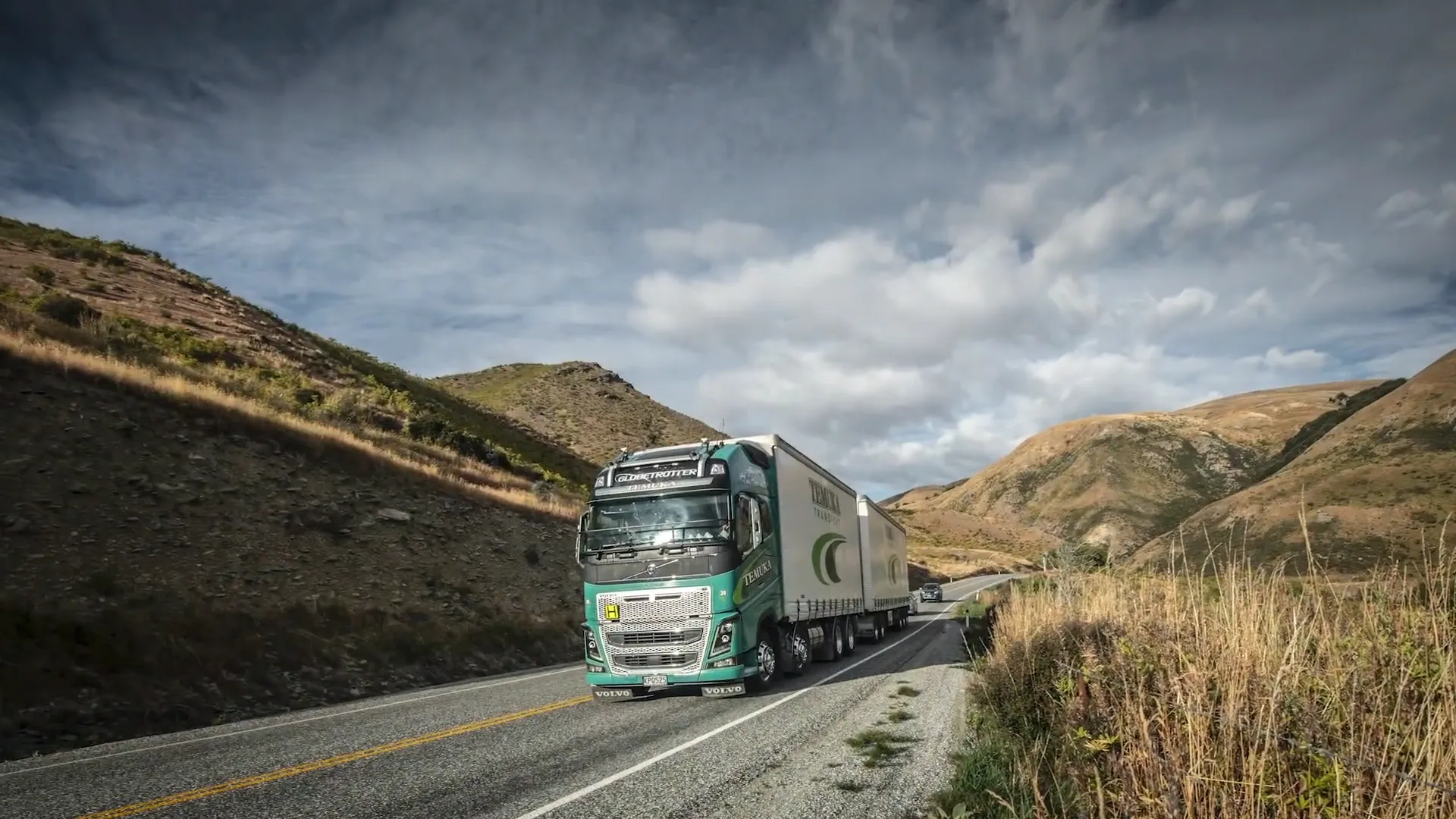 M2X and Temuka Transport logos over a photo of a Temuka Transport truck driving along the road