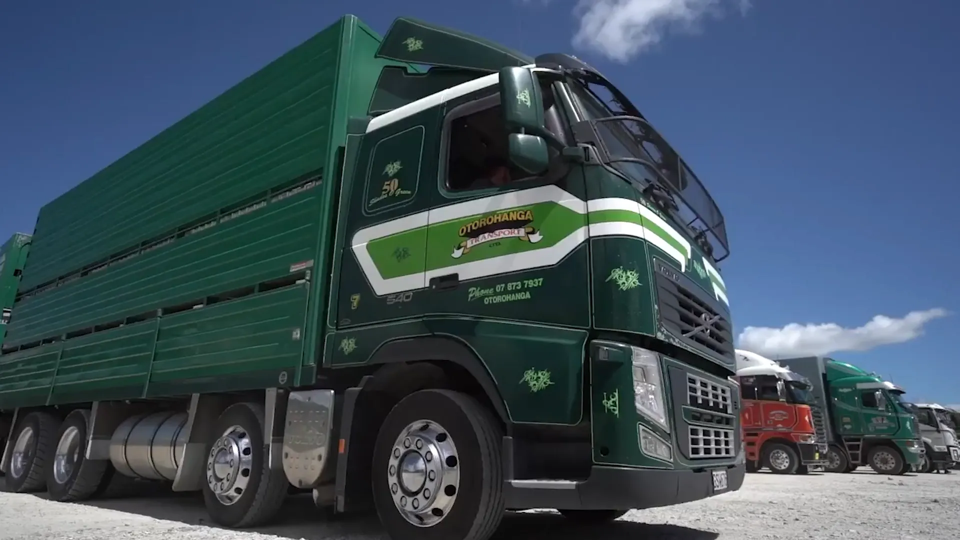 M2X and Otorohanga Transport logos over a photo of a Otorohanga Transport livestock truck driving at a farm