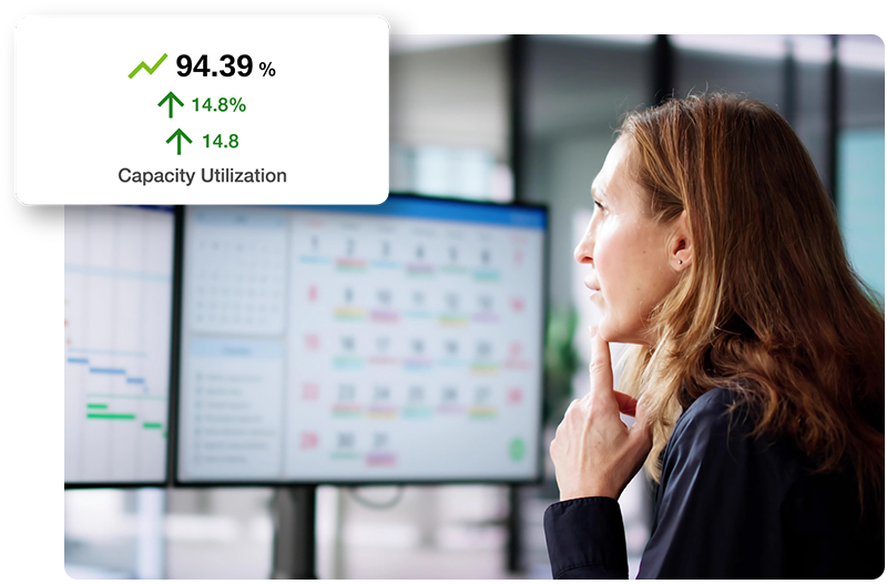 Dispatcher looking at computer, with capacity utilization graphic above