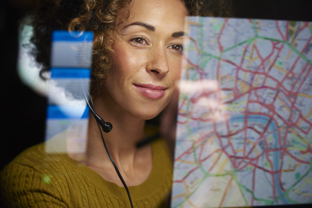 Dispatcher looking at computer screen with map