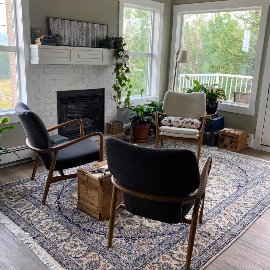 sitting room with big windows a fire place three wooden chairs spiritual direction cochrane alberta session space
