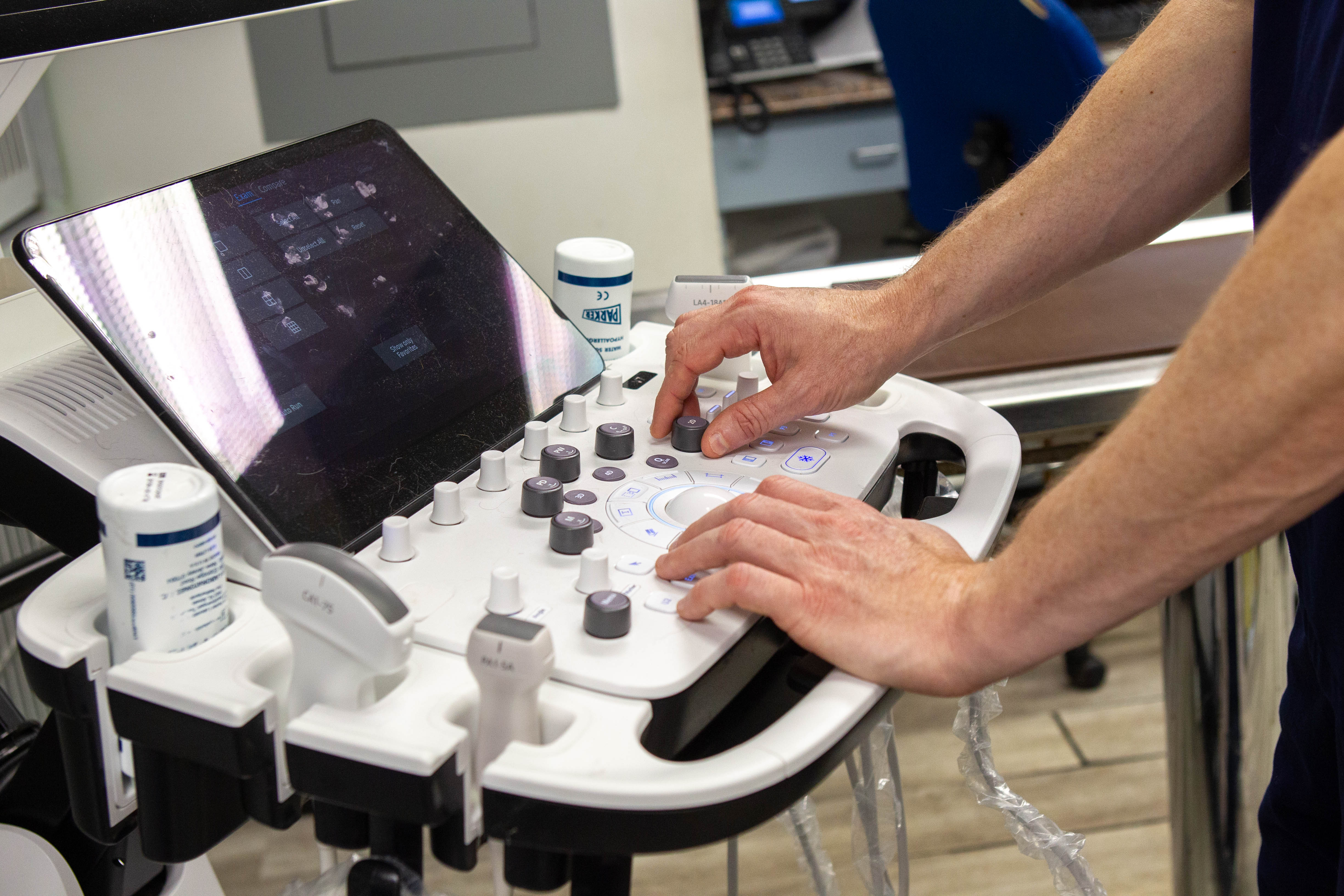 The veterinary team reviewing ultrasound images with a pet owner, highlighting compassionate service and advanced equipment