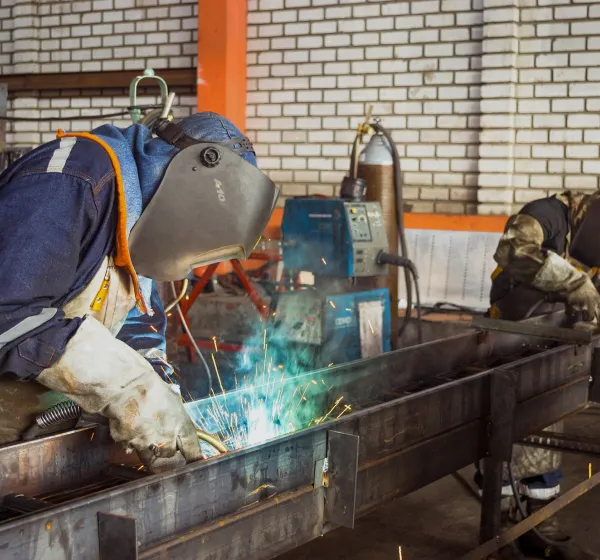 Welders working on steal column