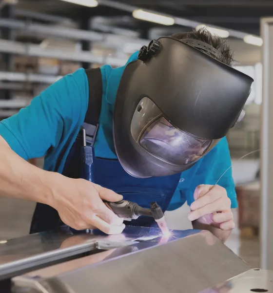 Welder working inside panel