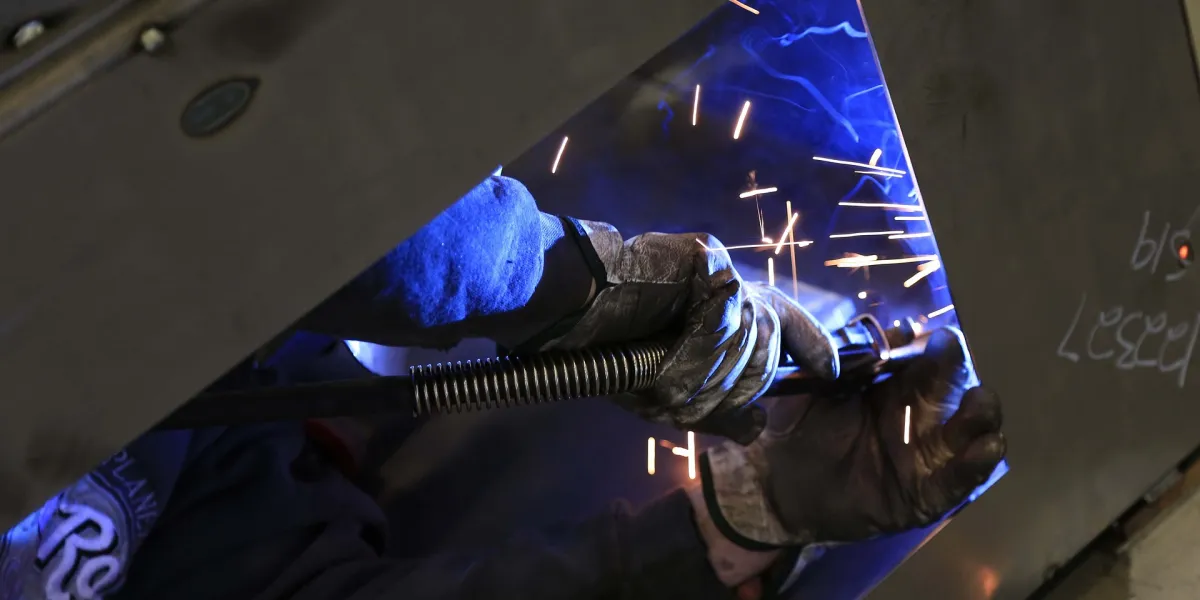 Welder working on panel