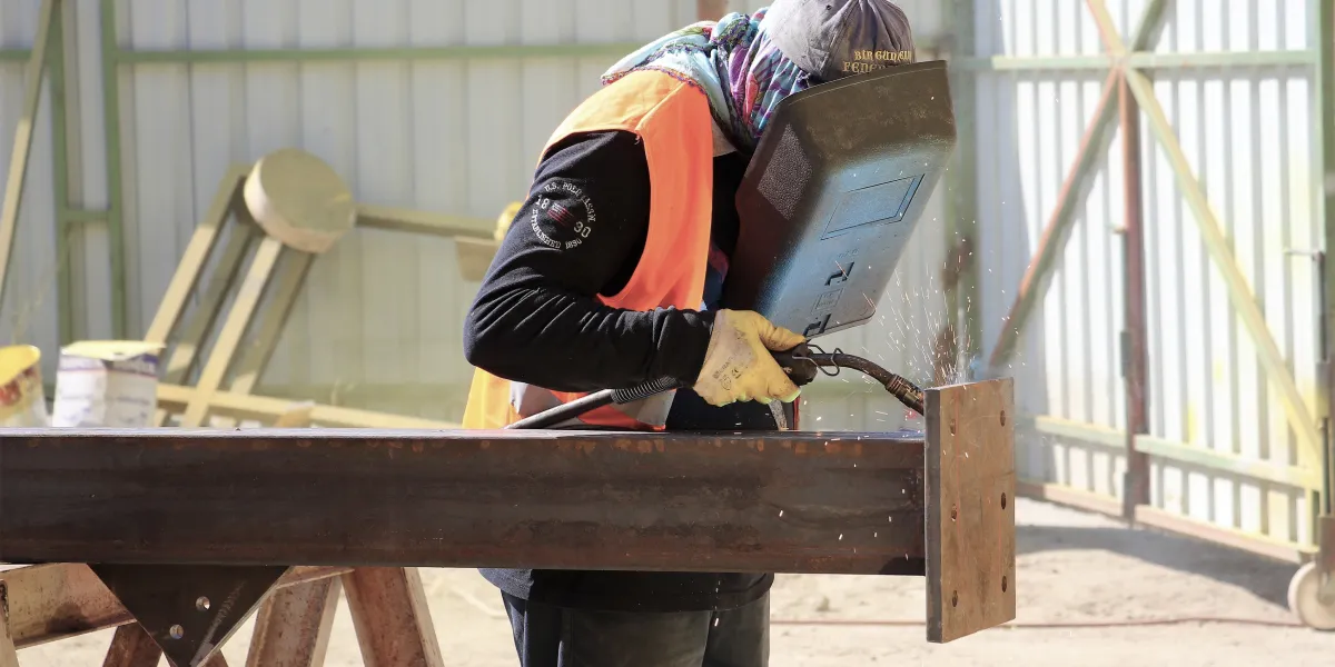 Welding working on beam