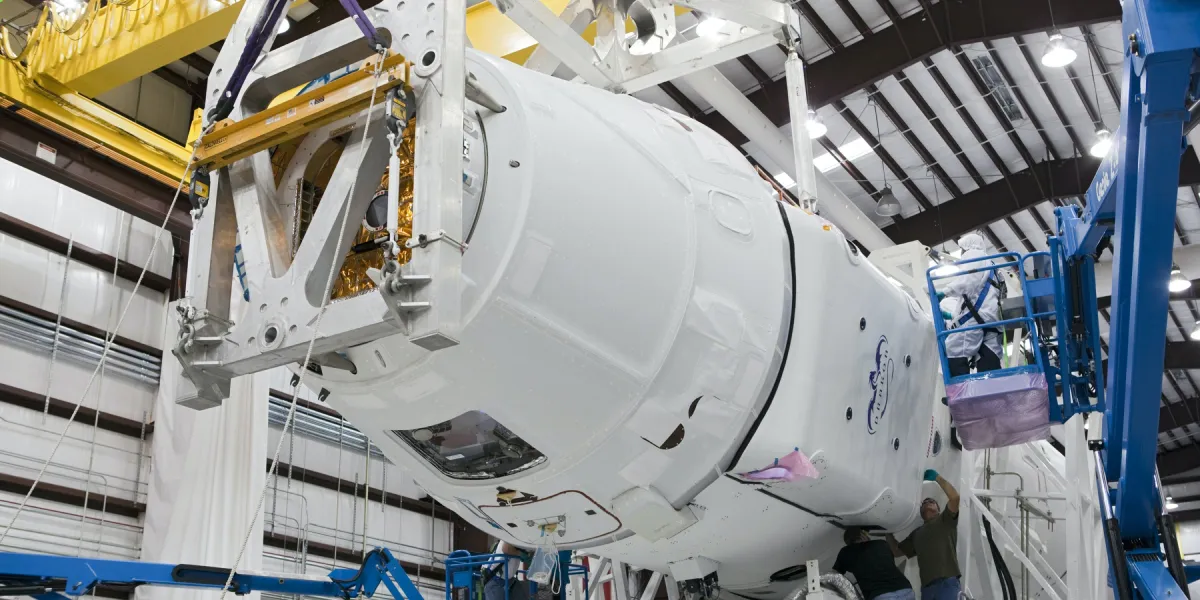 Workers assembling Space X capsule