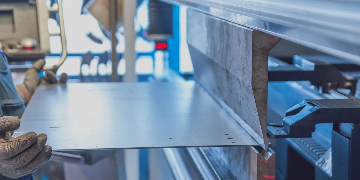 Worker fabricating new metal sheet