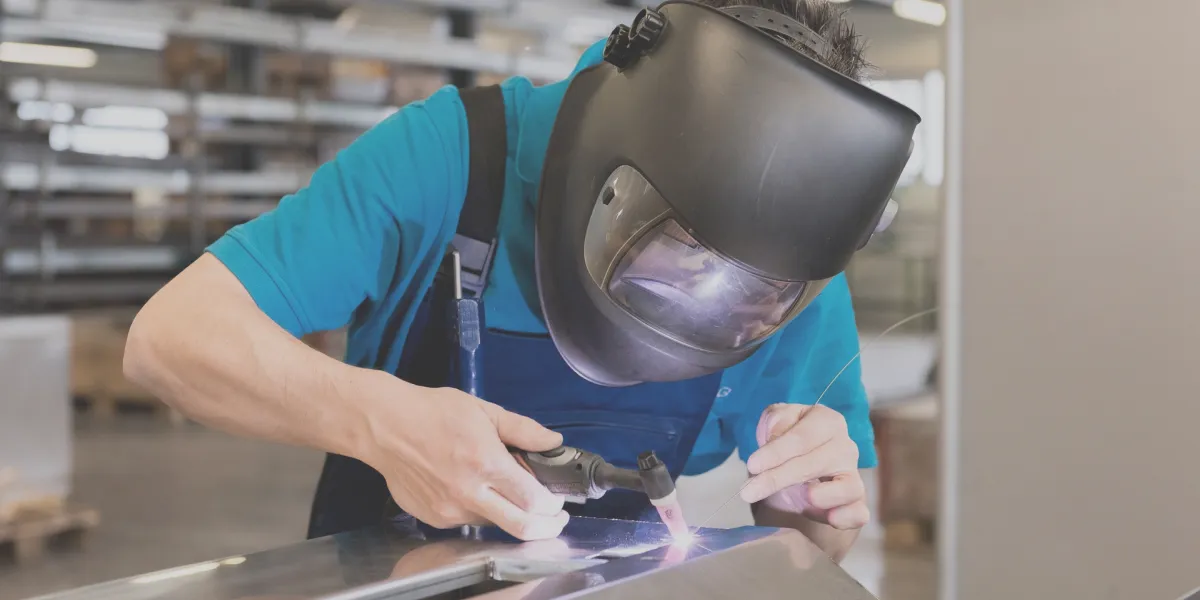 Welder working inside panel